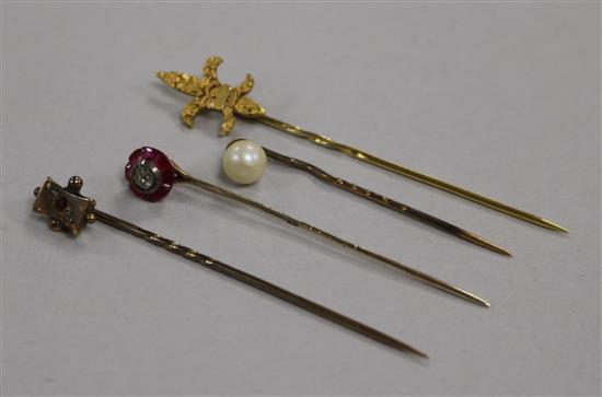 A Victorian ruby and diamond stick pin and three other stick pins,